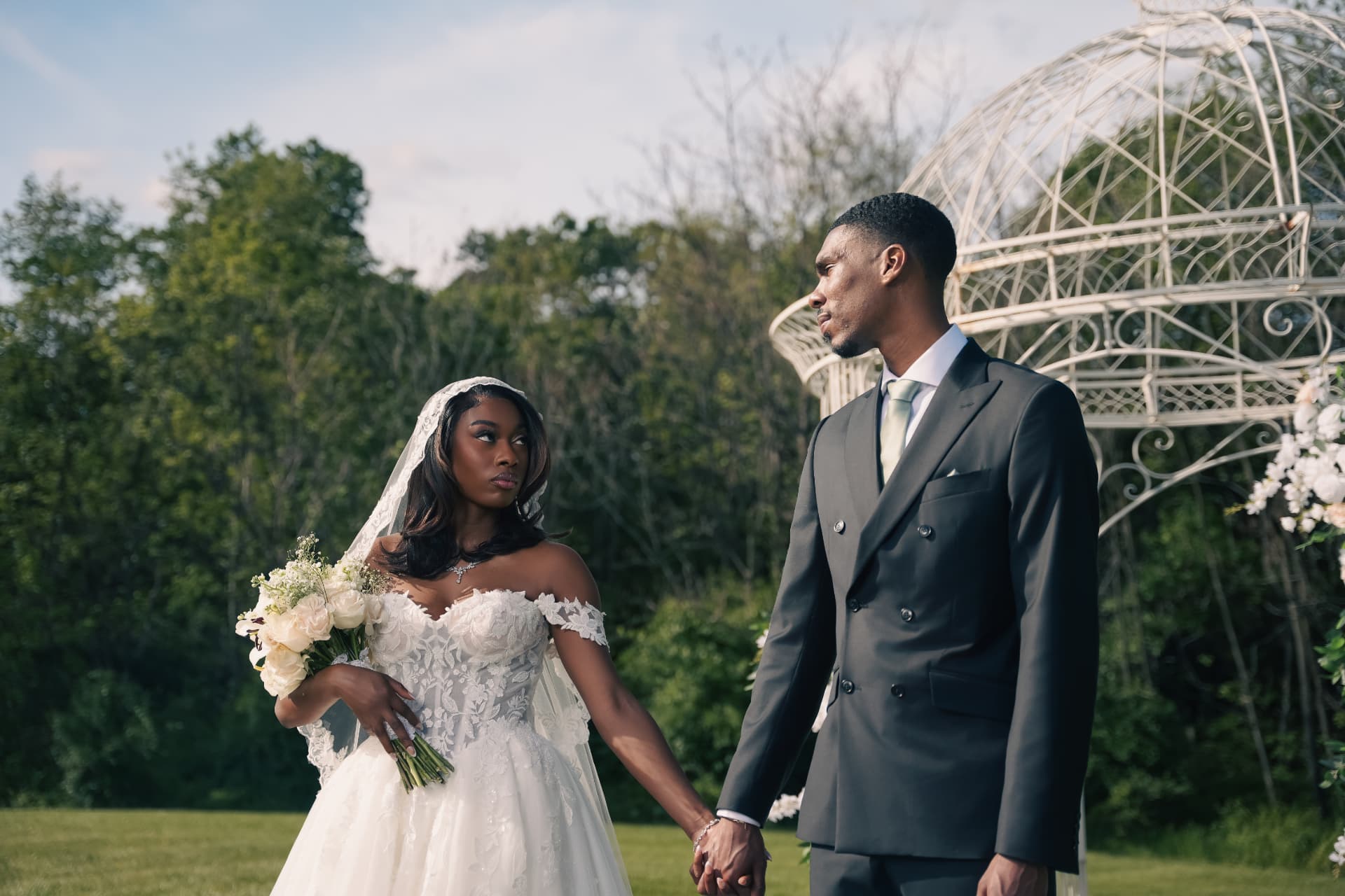 Bride and groom holding hands outdoors