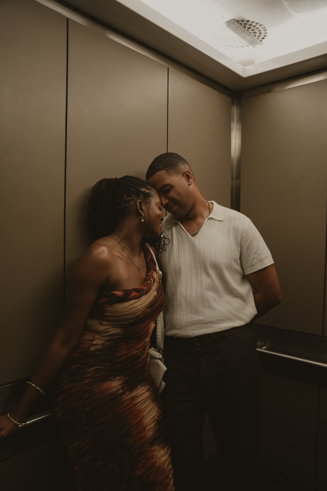 Couple sharing a quiet moment in an elevator