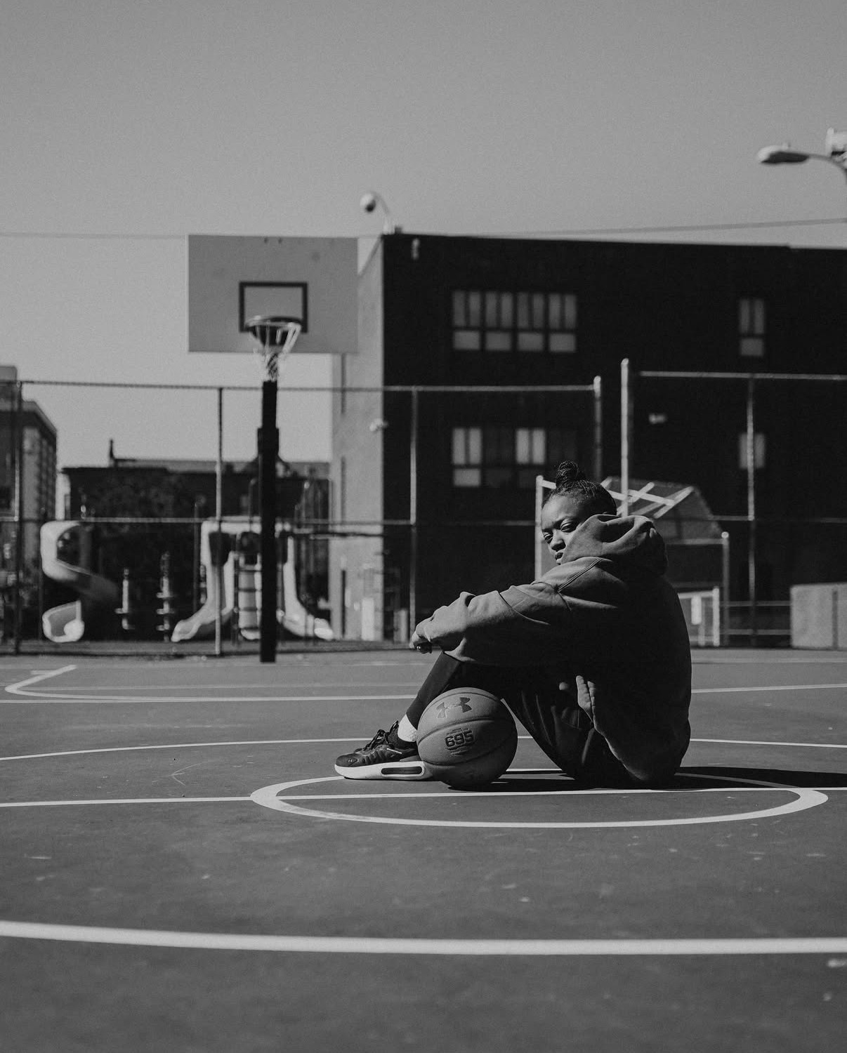 Black-and-white athlete portrait on a city court