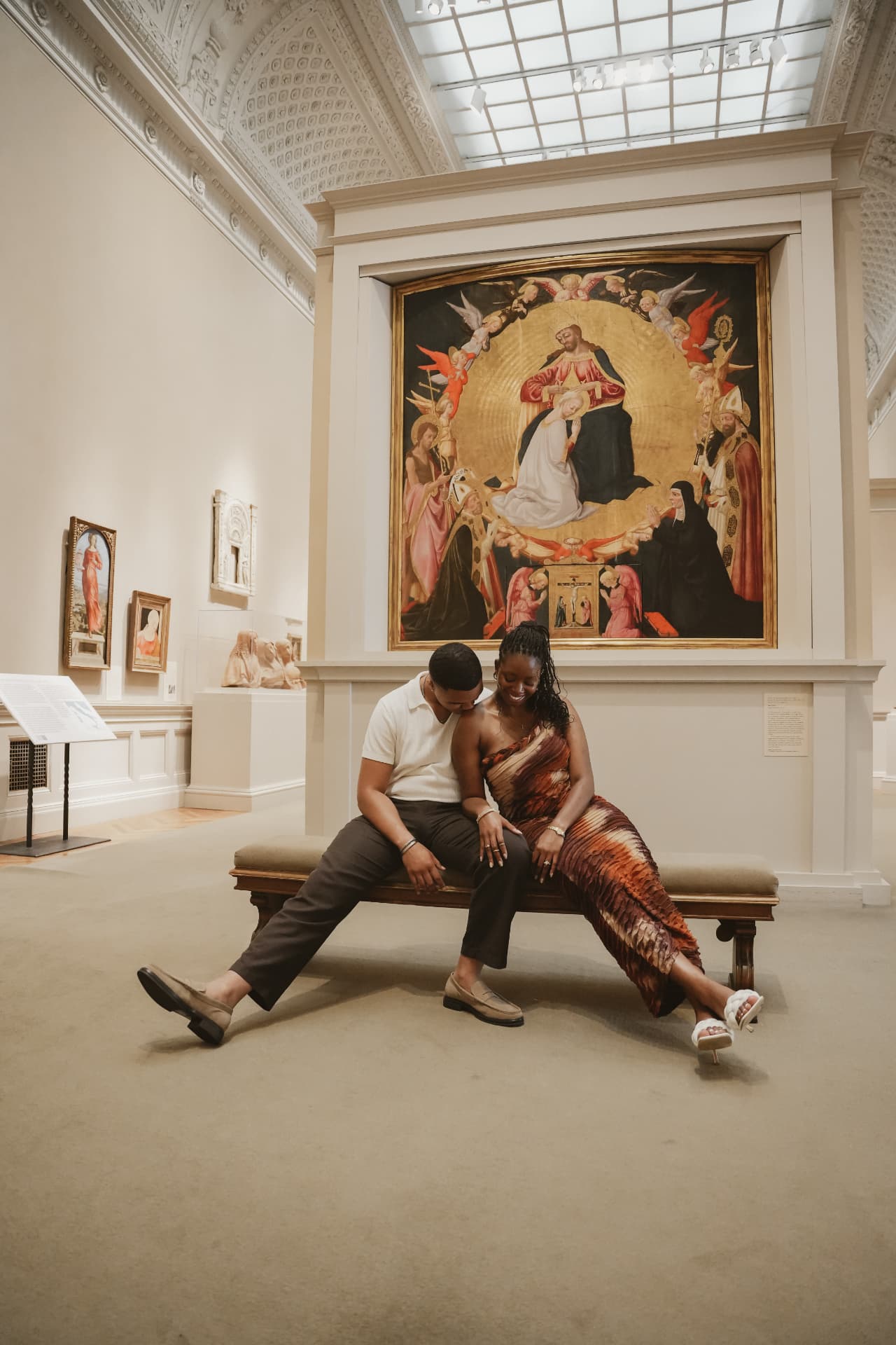 Engaged couple on a museum gallery bench